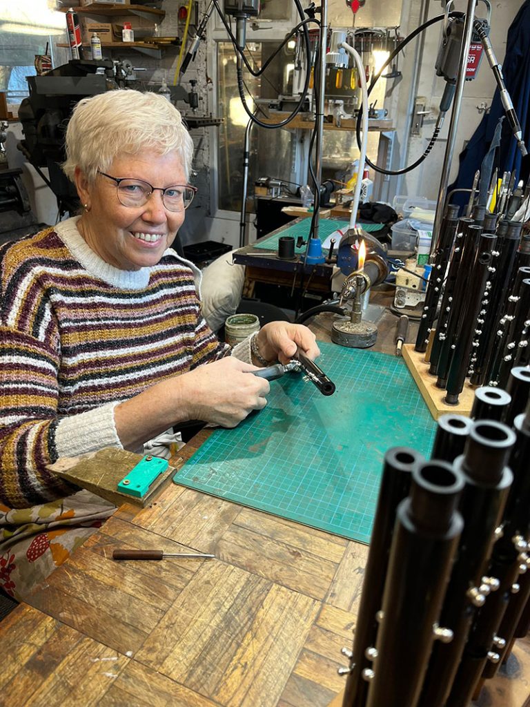 Gill who makes musical instruments for a living at work